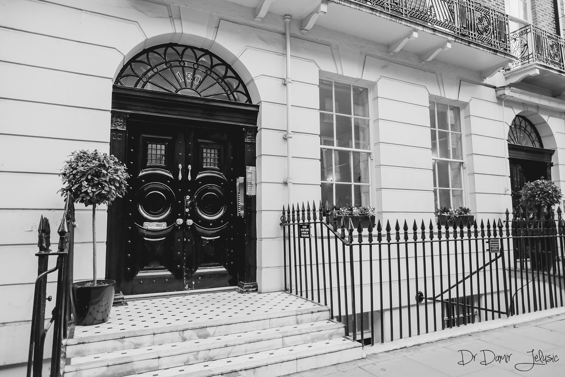 Black and white photo of a Georgian townhouse clinic entrance at our Chelsea clinic, Nobel Biocare dental implants London